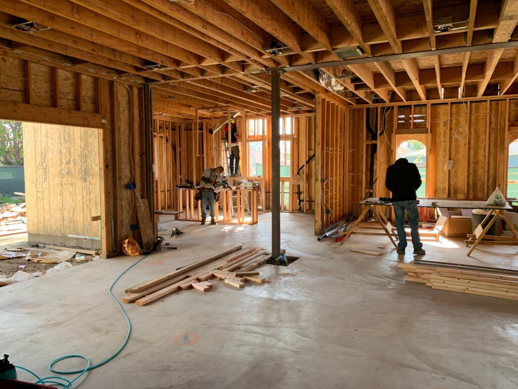 pexels-photo-4642437-4642437 Workers constructing a house framework, showcasing interior carpentry and building process.
